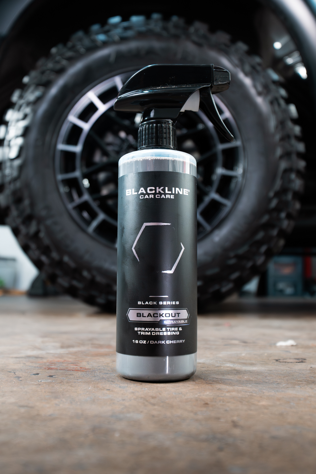Blackline Car Care BLACKLINE® Blackout Trim and Tire Dressing applied on car tires and trim for a sleek, polished look.
