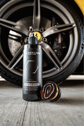 Blackline Car Care BLACKLINE® Blackout Trim and Tire Dressing applied to car tires and trim for a sleek, matte finish.