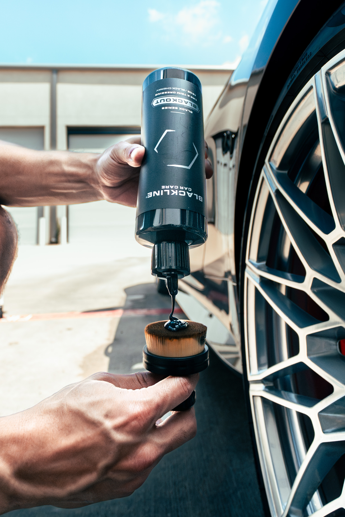 Blackline Car Care BLACKLINE® Blackout Trim and Tire Dressing applied to car tires and trim for a sleek, polished appearance.