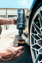 Blackline Car Care BLACKLINE® Blackout Trim and Tire Dressing applied to car tires and trim for a sleek, polished appearance.