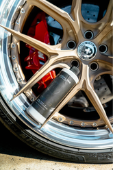 Blackline Car Care BLACKLINE® Blackout Trim and Tire Dressing applied to car tires and trim for a sleek, matte finish.