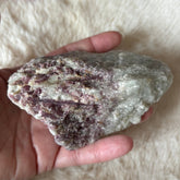 Raw pink tourmaline gemstone from Evermore Everlasting, showing its natural pink crystal structure and rough, unpolished appearance.