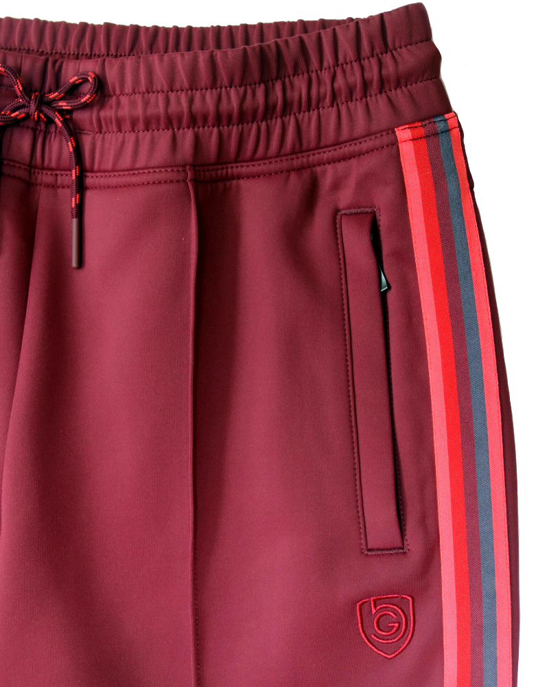 Goal Five Powerstripe mid-rise 28-inch track pants with 7/8 length, shown in a lifestyle setting.