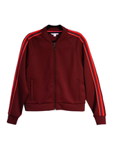 Goal Five Powerstripe LS Track Jacket in lifestyle setting, featuring a sleek design with striped details and sporty style.