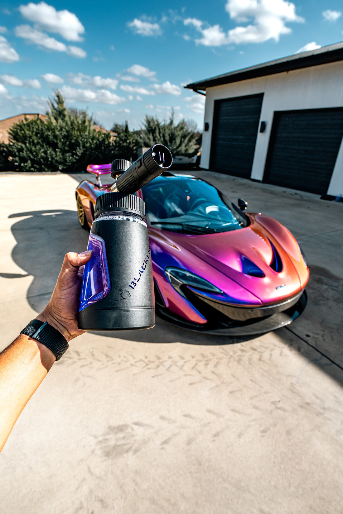 Blackline Car Care BLACKLINE® Ultra Series Foam Cannon attached to a garden hose, producing thick foam for car washing.