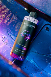 Blackline Car Care BLACKLINE® Ultra Foam car shampoo bottle with foam applicator, ready for washing a vehicle.