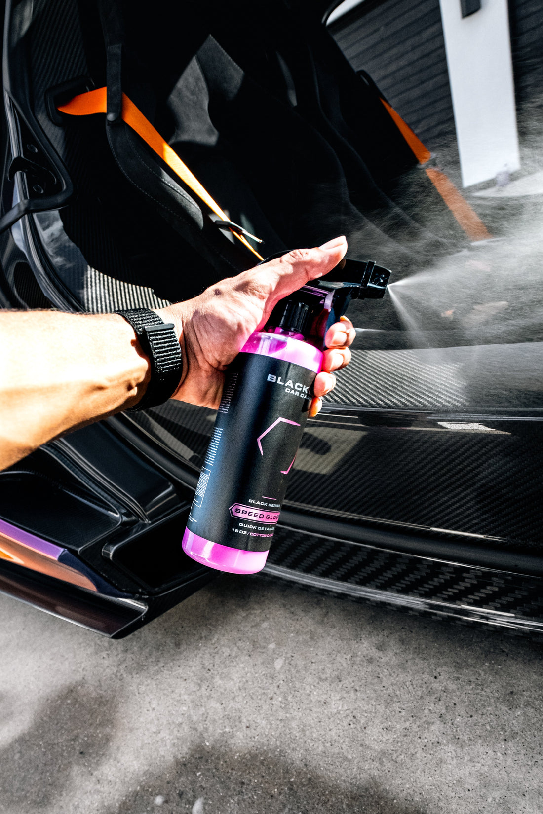 Blackline Car Care BLACKLINE® SPEED GLOSS Quick Detailer gloss spray bottle with applicator pad on a car surface.