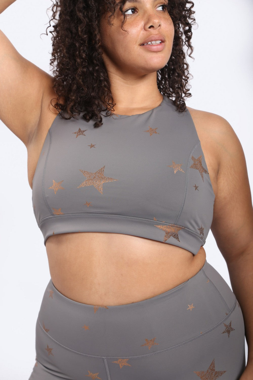 Copper star print Fitkitty Culture sports bra with foil finish, designed for activewear and yoga.