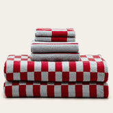 White Pietra Australian cotton towels by Italic with a plush texture and subtle striped pattern, displayed folded on a neutral background.