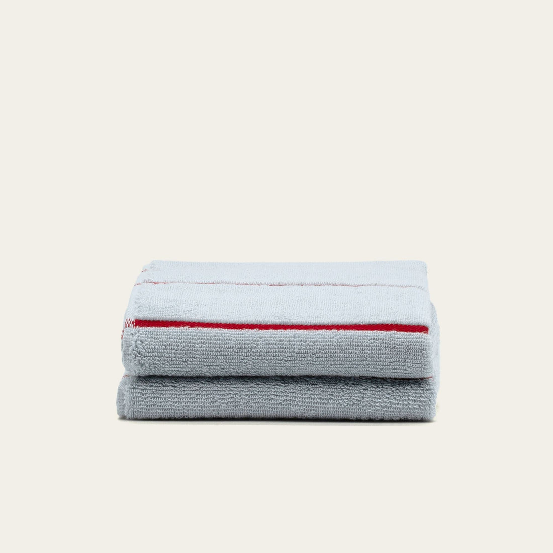 Soft beige Deia Australian Cotton Towels from Italic, shown in a cozy home bed setting with textured fabric details.