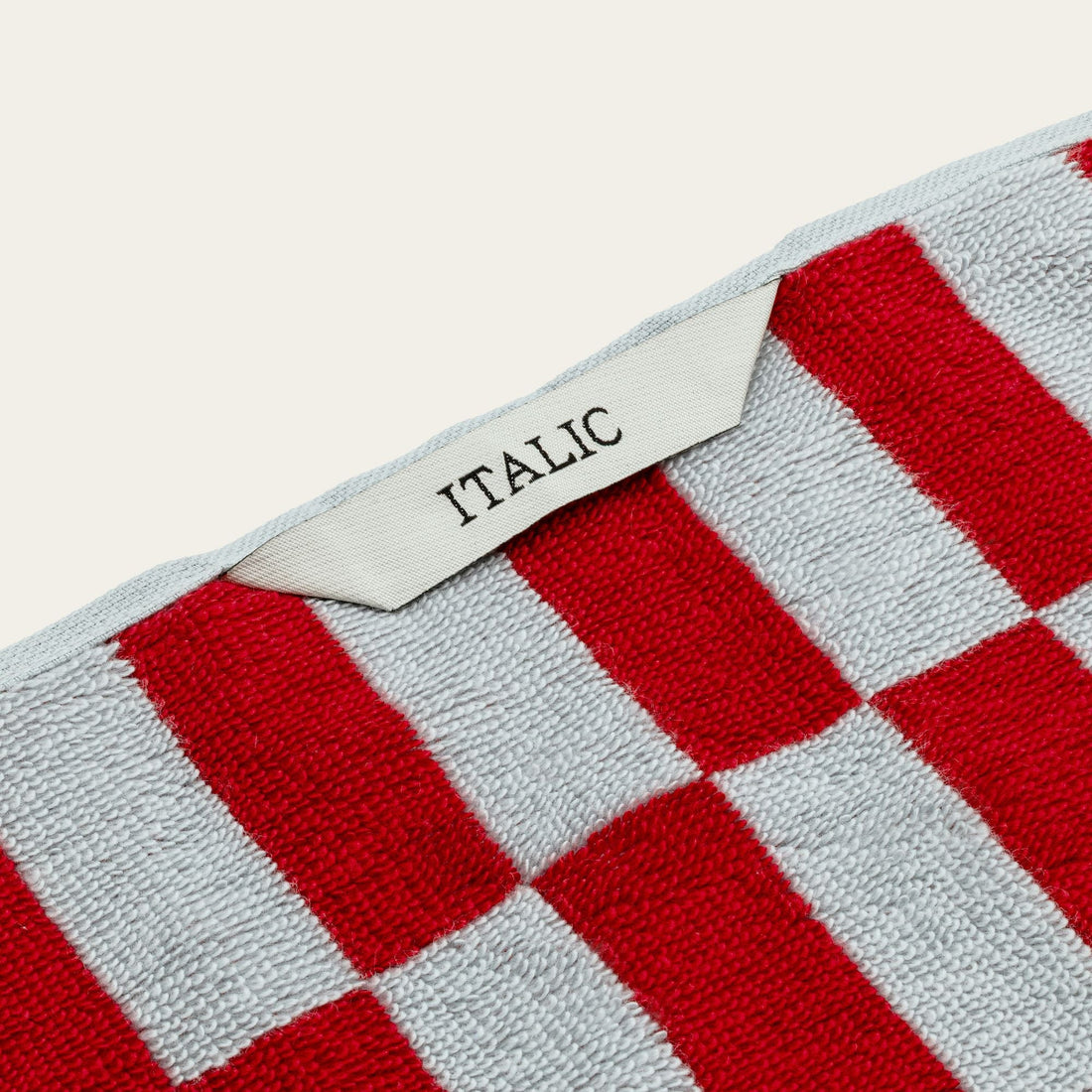 White Pietra Australian Cotton Towels by Italic, soft and plush with a textured weave, displayed hanging on a towel rack.