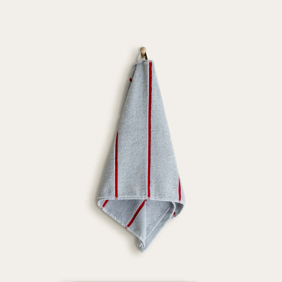 Soft white Deia Australian cotton towel from Italic, displayed on a bed in a cozy home setting.