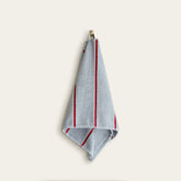 Soft white Deia Australian cotton towel from Italic, displayed on a bed in a cozy home setting.