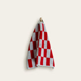 White Pietra Australian cotton towels by Italic, soft and plush, draped over a wooden surface.