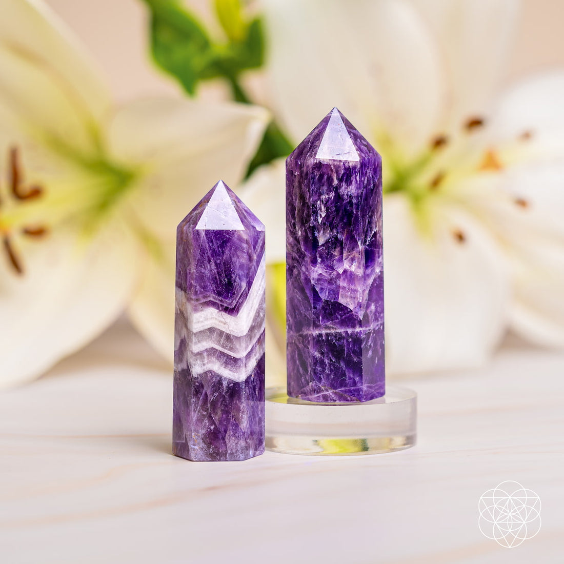 Chevron Amethyst Point of Transformation crystal for home decoration, showcasing purple and white banding with a pointed shape.