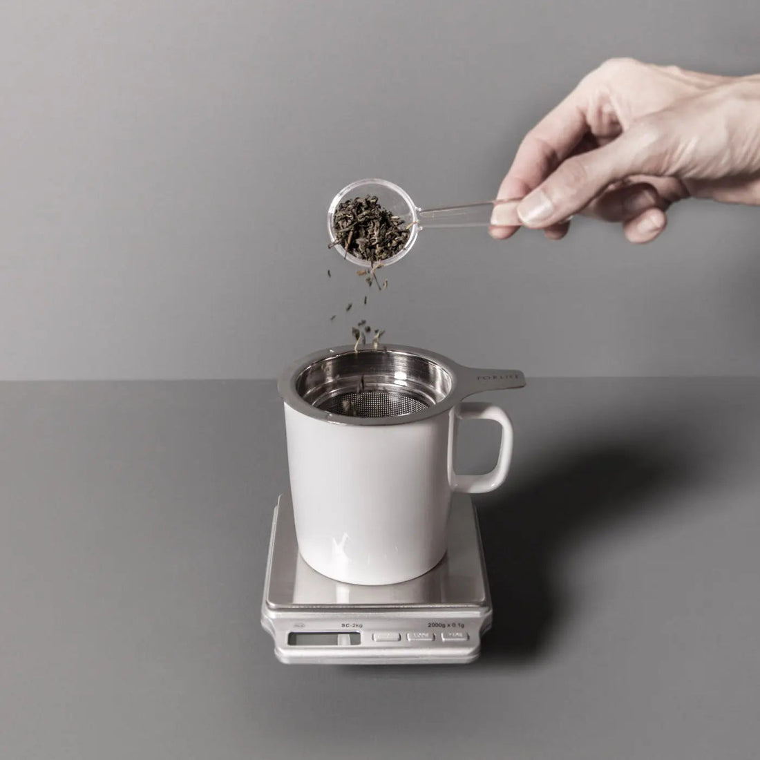 August Uncommon Tea precision scale for teaware, showing a close-up of the digital display used for consistent tea flavor measurement.