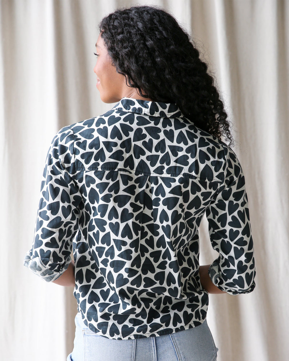 Downeast More Love top in soft fabric, featuring a casual fit with a stylish neckline, displayed on a hanger.