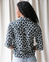 Downeast More Love top in soft fabric, featuring a casual fit with a stylish neckline, displayed on a hanger.
