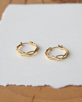 Downeast braided hoop earrings featuring a stylish, intertwined design in a polished metal finish.