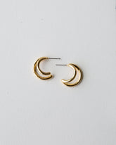 Downeast double hoop earrings featuring two large gold-toned hoops with textured surface, stylish and elegant jewelry accessory.