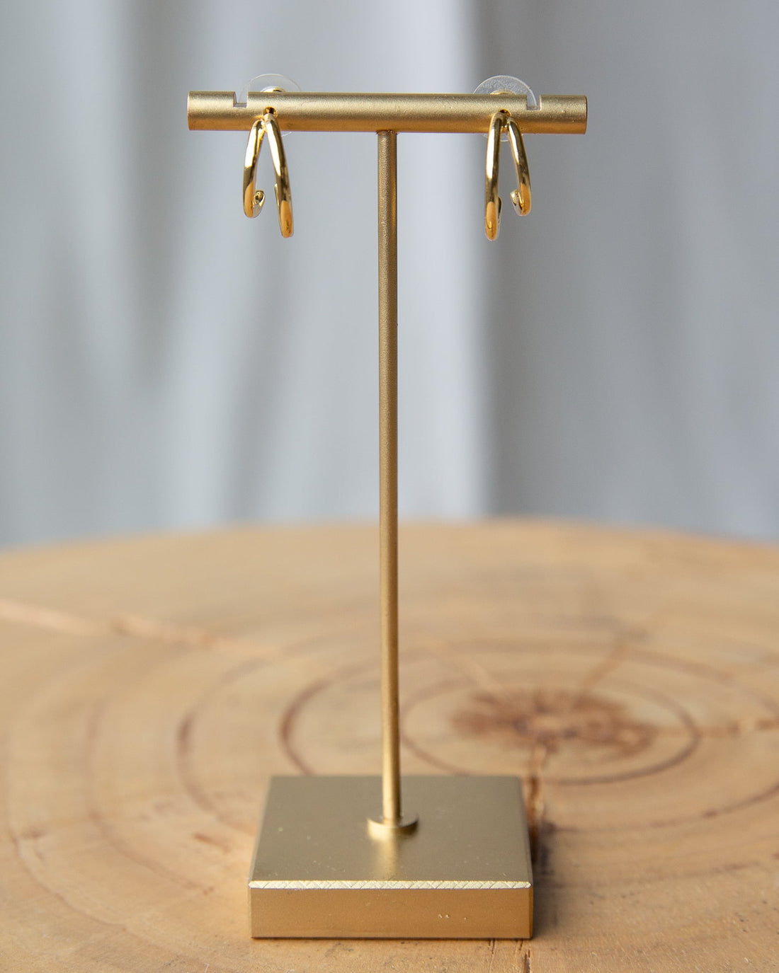 Downeast double hoop earrings featuring two interconnected gold-toned hoops on a white background.