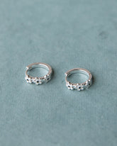 Silver In Bloom Huggie Hoop earrings by Downeast, featuring delicate floral design in sterling silver.