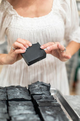 Handmade charcoal and goat milk soap bar by Pretty Farm Girl, showcasing a natural, rustic bar soap with a textured surface.
