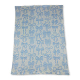 Light blue bows and white polka dots baby girl blanket made of soft minky fabric by Mini Rodeo.