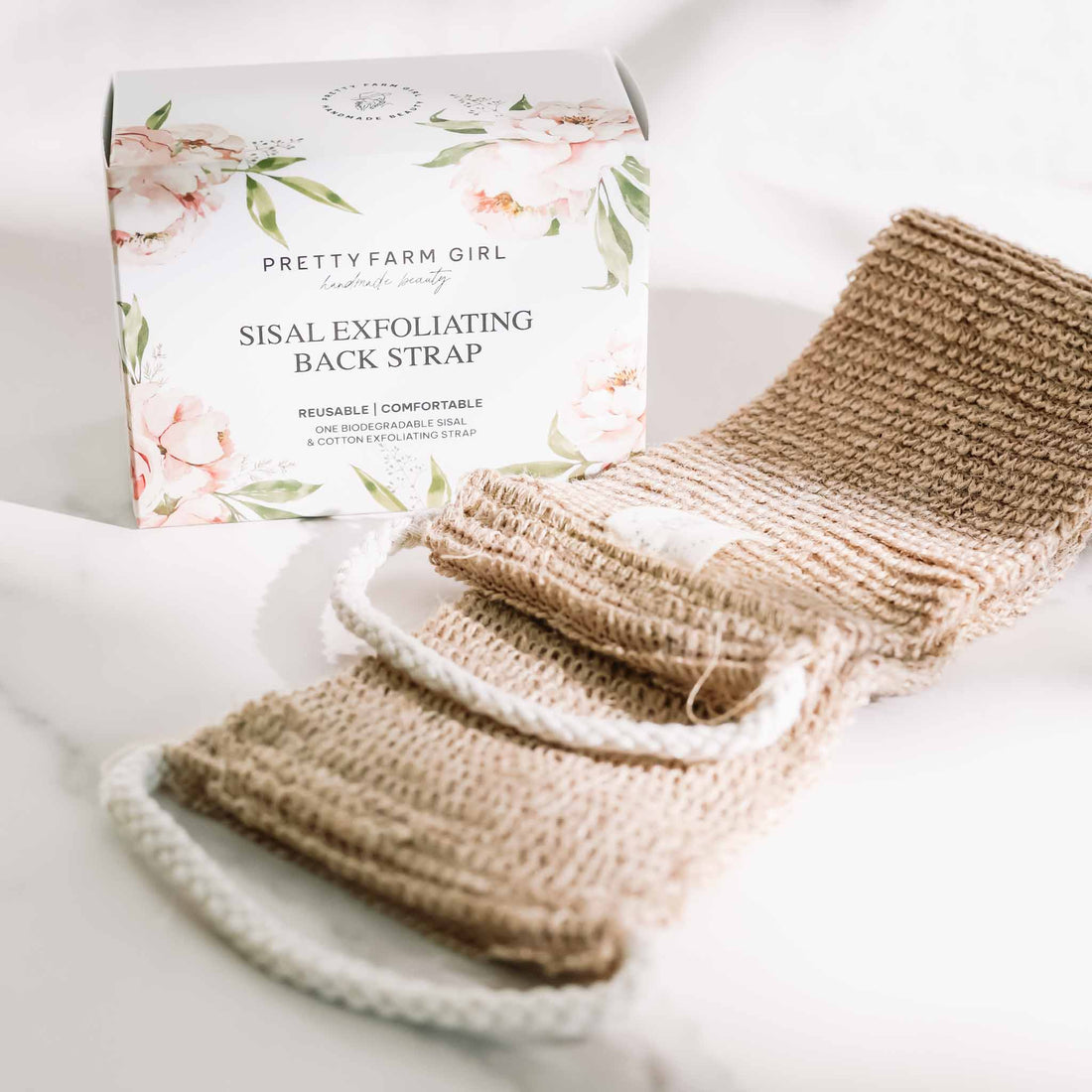 Pretty Farm Girl sisal back exfoliating strap, a natural exfoliation accessory with textured surface for deep skin cleansing.