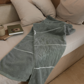 White Deia Australian cotton bath towels by Italic, soft and plush, displayed on a bed for home use.