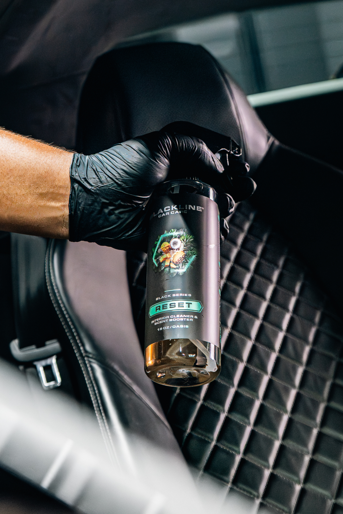 Blackline Car Care BLACKLINE® RESET interior cleaner and scent booster spray in a black bottle with a spray nozzle.