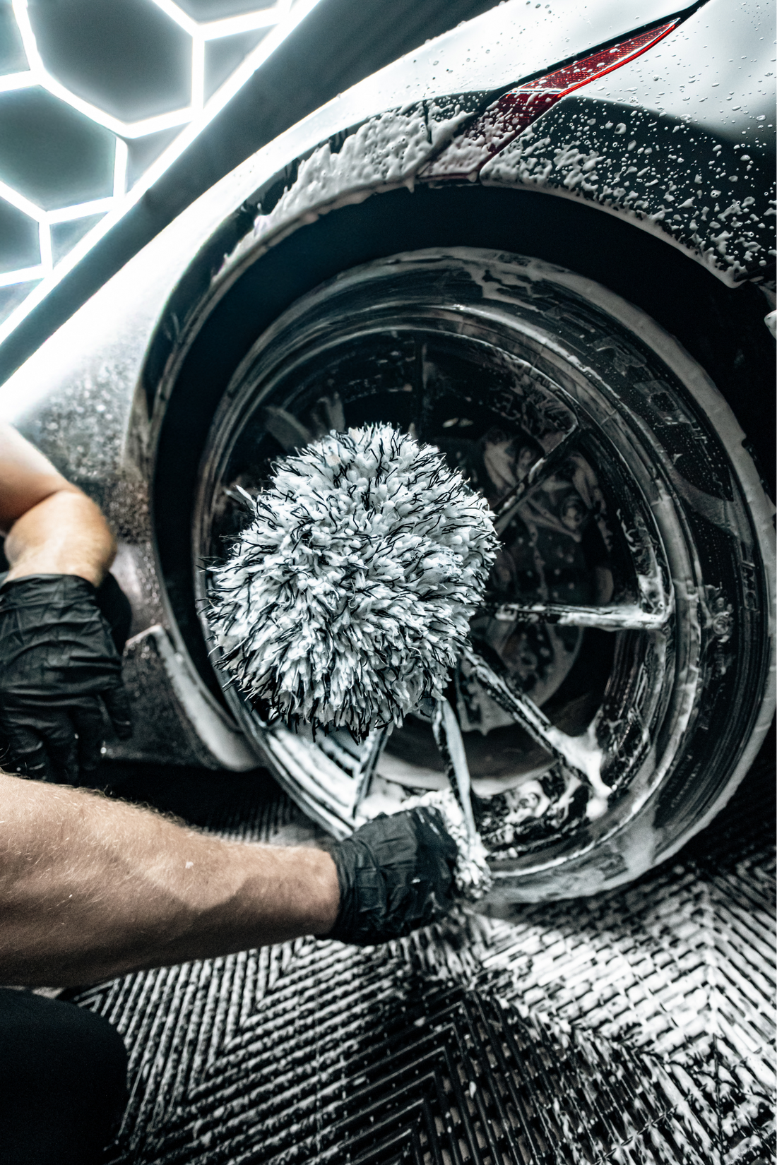 Blackline Car Care Blackline microfiber wheel mitt in use, showing its soft, flexible material for cleaning car wheels effectively.