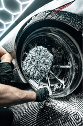 Blackline Car Care Blackline microfiber wheel mitt in use, showing its soft, flexible material for cleaning car wheels effectively.