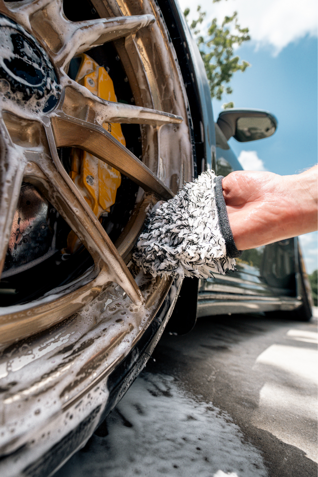 Blackline Car Care BLACKLINE® microfiber wheel mitt in use, showing soft, plush material for cleaning car wheels effectively