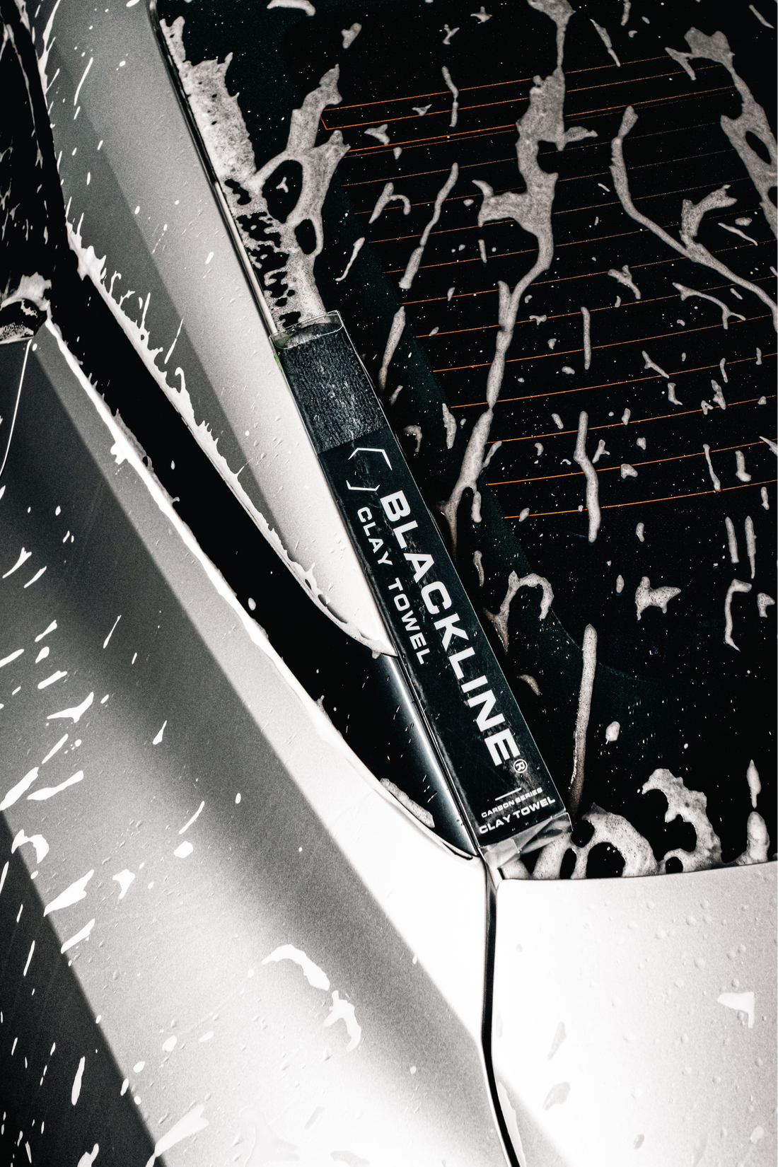 Blackline Synthetic Clay Towel in black case, designed for car detailing and paint surface cleaning.
