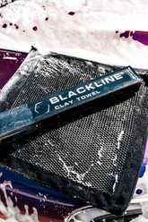 Close-up of Blackline Car Care BLACKLINE® Synthetic Clay Towel showing its textured surface for removing contaminants from vehicle paint.