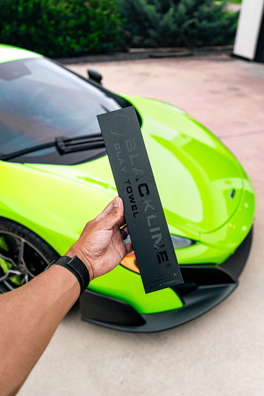 Blackline Synthetic Clay Towel for car detailing, shown on a sleek McLaren vehicle, designed for smooth, effective paint surface cleaning.