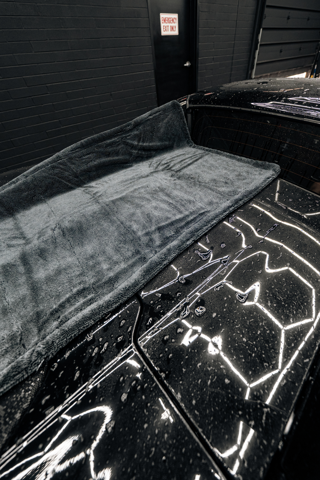 Blackline Car Care BLACKLINE® twisted-loop drying towel draped over a car for gentle, effective drying.