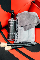 Blackline Car Care BLACKLINE® RESET interior cleaner and scent booster on a Ferrari F12 seat, showing the product bottle and clean interior.
