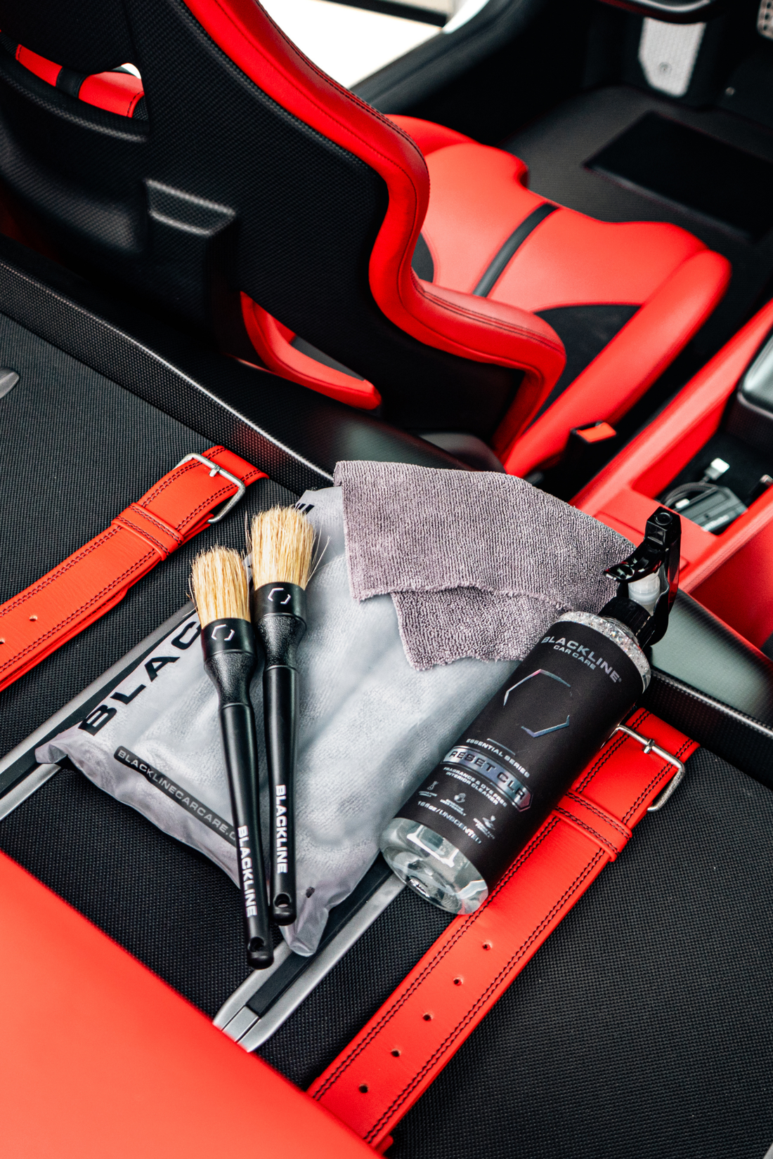 Blackline Car Care BLACKLINE® RESET interior cleaner and scent booster bottle inside a Ferrari F12 trunk.