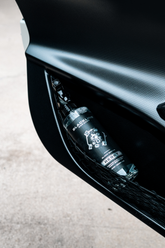 Blackline Car Care BLACKLINE® RESET interior cleaner and scent booster applied to a dark ice car door panel.
