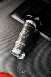 Blackline Car Care BLACKLINE® RESET interior cleaner and scent booster bottle on a dark ice floor mat.
