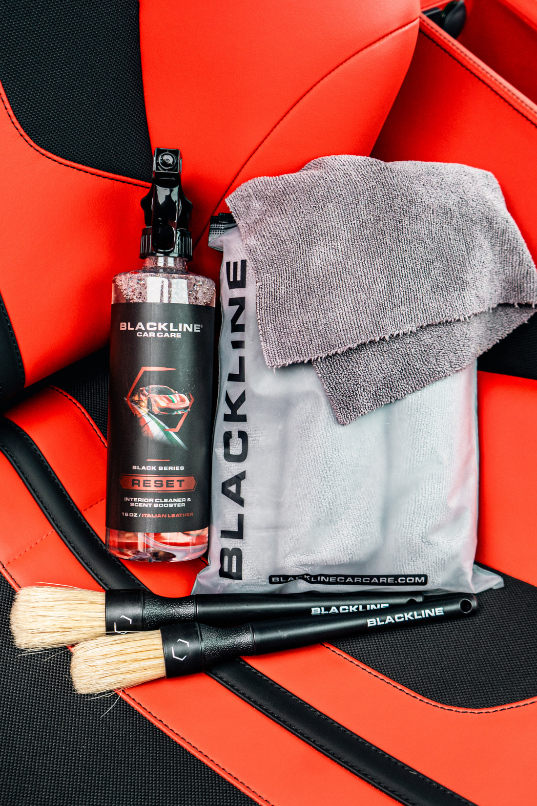 Blackline Car Care RESET interior cleaner and scent booster on Ferrari F12 leather seat, highlighting the interior cleaning system.