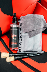 Blackline Car Care RESET interior cleaner and scent booster on Ferrari F12 leather seat, highlighting the interior cleaning system.