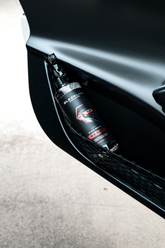 Blackline Car Care BLACKLINE® RESET interior cleaner and scent booster applied to a black leather door panel in a car.