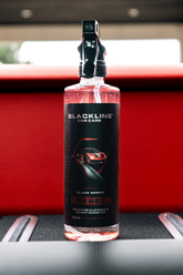 Blackline Car Care RESET interior cleaner and scent booster bottle with Italian leather scent, black label, and spray nozzle.