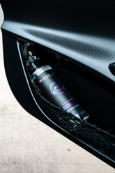Blackline Car Care BLACKLINE® Reset interior cleaner and scent booster applied to a car door panel, showcasing its cleaning and freshening effect.