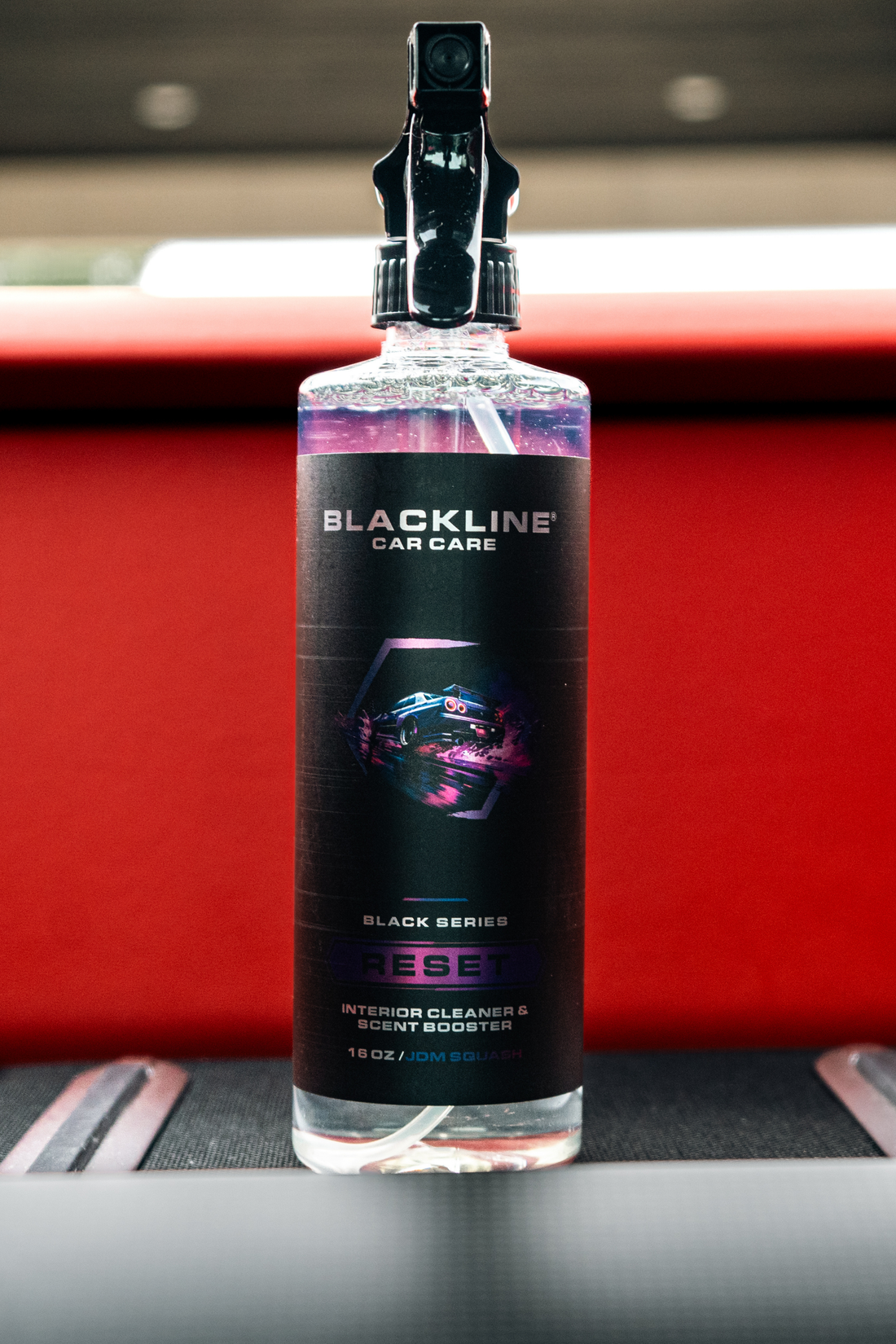 Blackline Car Care BLACKLINE® RESET interior cleaner and scent booster bottle with label and spray nozzle.
