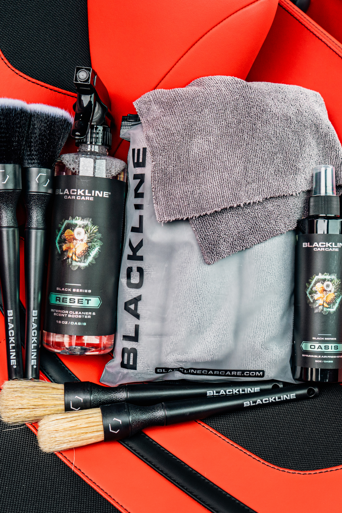 Blackline CAR CARE BLACKLINE® RESET interior cleaner and scent booster in a Ferrari F12 seat, showcasing a clean and refreshed car interior.