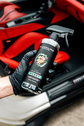 Blackline Car Care BLACKLINE® RESET interior cleaner and scent booster bottle held in hand, showing product label and packaging.